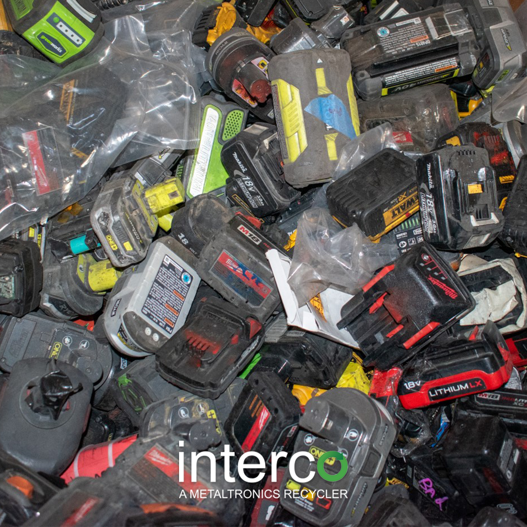 A large pile of assorted used lithium-ion power tool batteries