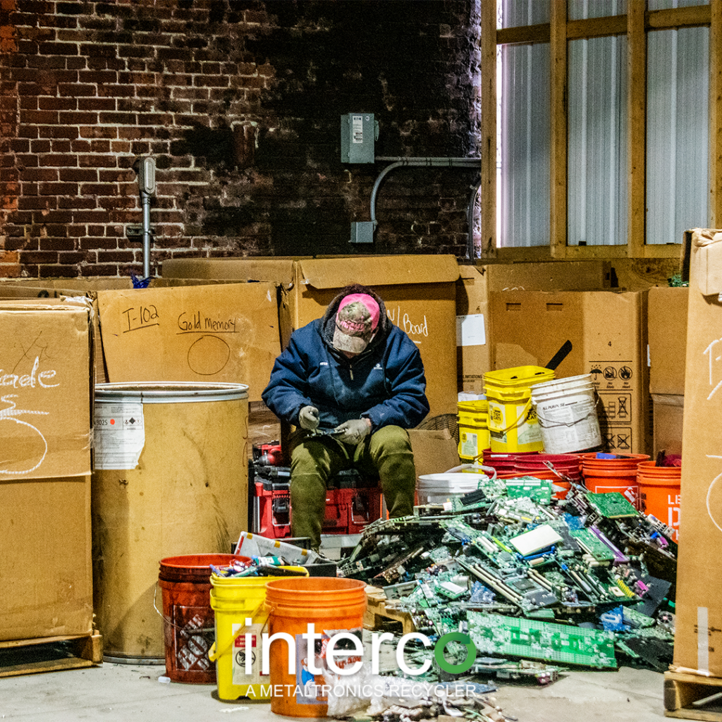 Man inspecting Scrap electronics